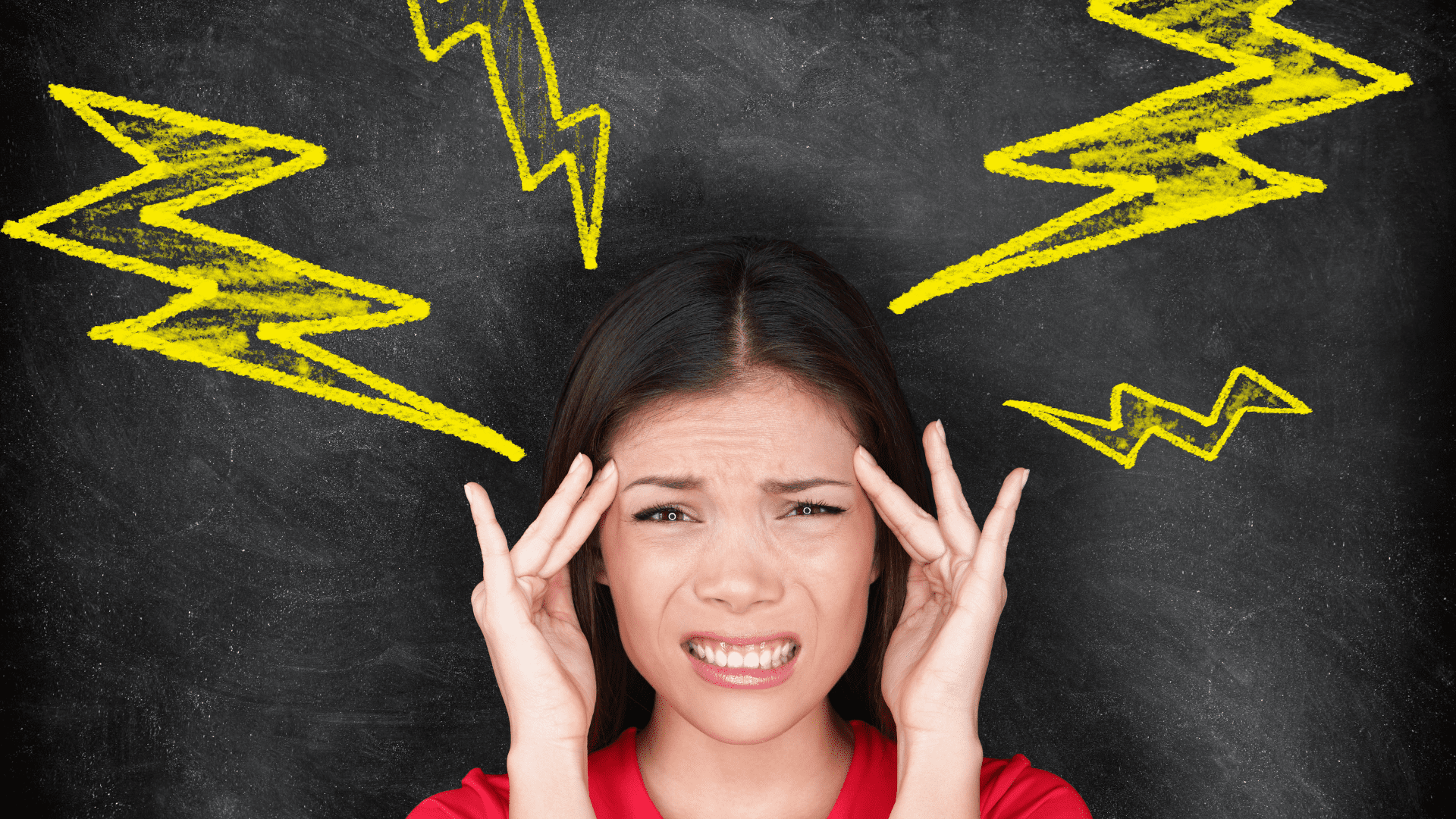 Woman holding her head with yellow lightning bolts drawn around her, symbolizing dysregulated nervous system. The image depicts a woman experiencing intense stress or headaches, which are common physical manifestations of a dysregulated nervous system. The yellow lightning bolts emphasize the sudden and sharp nature of these symptoms.