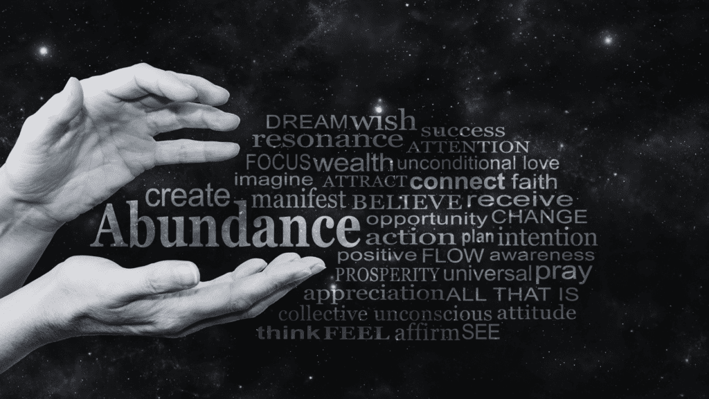 Open hands surrounded by a word cloud with terms like abundance, wealth, and gratitude, representing the concept of holistic wealth.

