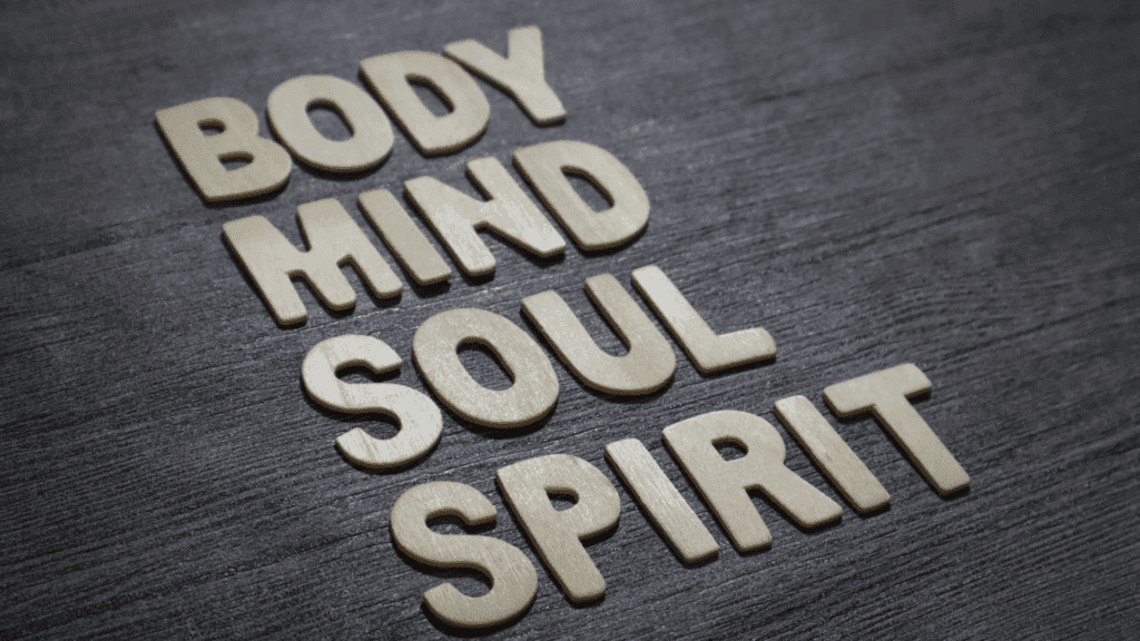 Holistic Psychology: A Neuroscience-Based Path to Total Wellness 2 Wooden letters spelling "Body, Mind, Soul, Spirit" on a dark wooden surface. Wooden letters arranged on a dark wooden surface spell out the words "Body, Mind, Soul, Spirit," emphasizing the foundation of holistic psychology in addressing all aspects of human well-being.