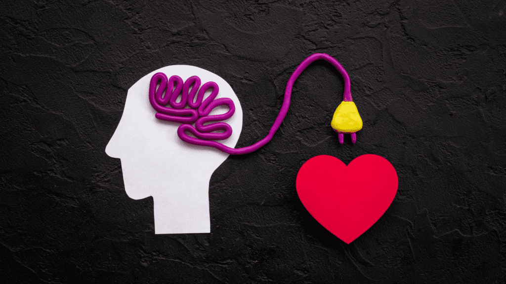 A visual representation of a brain connected to a heart by a cord, emphasizing the mind-body connection.


