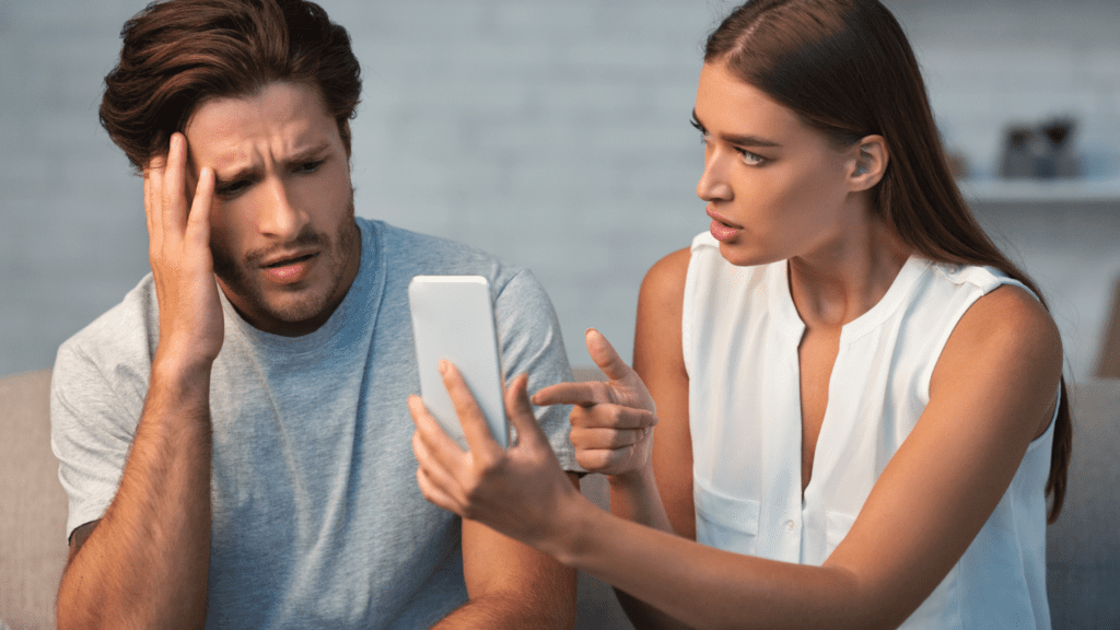 Living a Double Life: The Neuroscience of Dual Identities 1 Person showing phone evidence while another reacts with distress, depicting moment of discovery