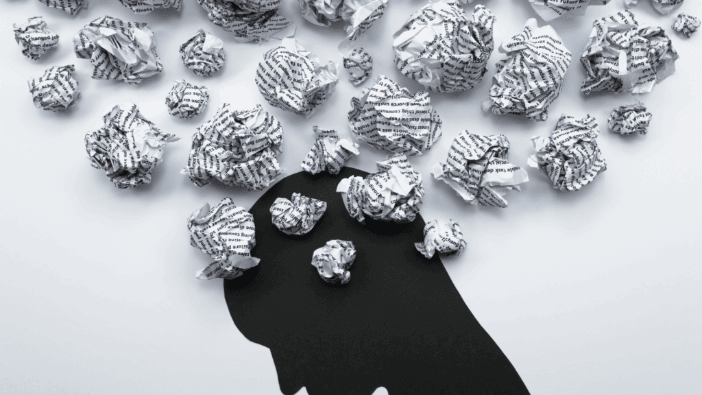 Mental Exhaustion Unveiled: A Neuroscience Perspective 4 conceptual illustration of mental exhaustion with paper thoughts emerging from silhouetted head