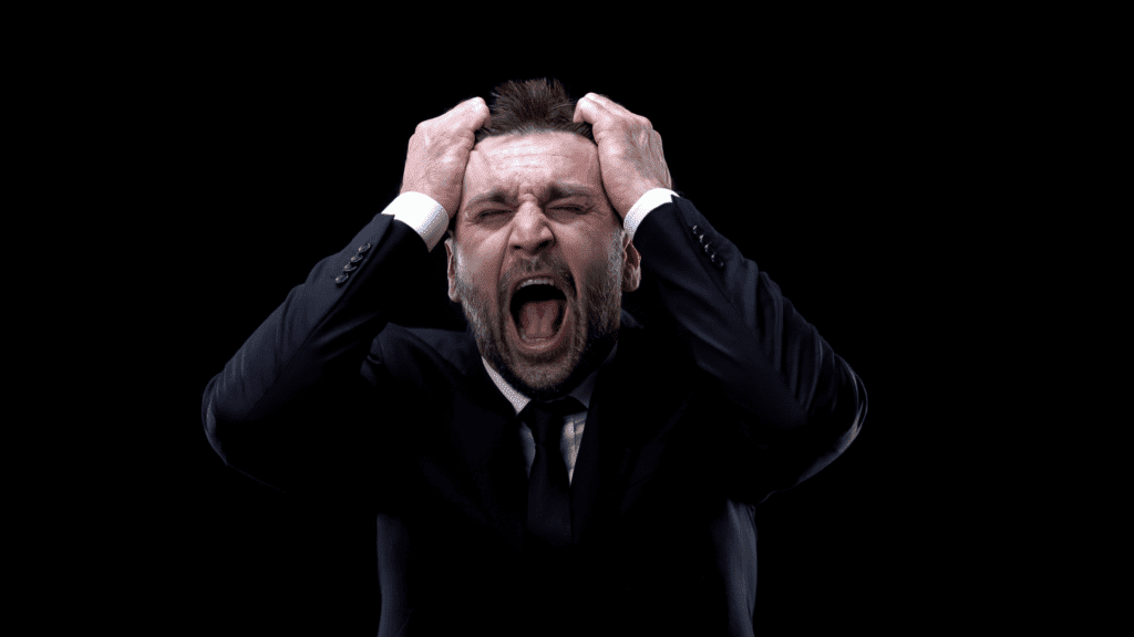 Mental Exhaustion Unveiled: A Neuroscience Perspective 3 businessman experiencing severe mental exhaustion with hands clutching head