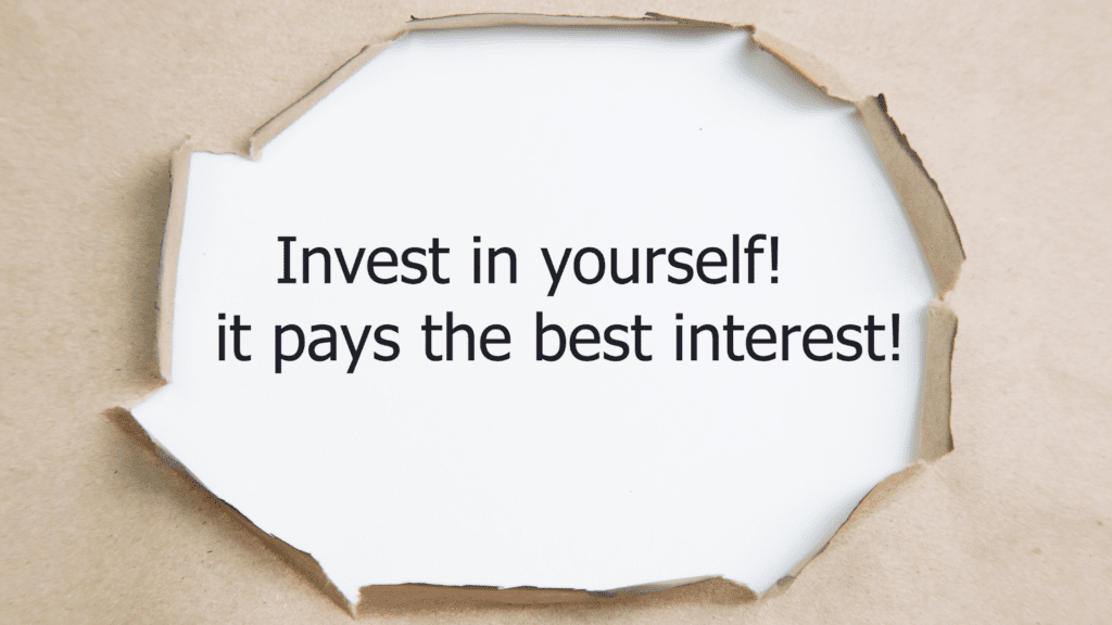 Motivational quote about self-investment through torn paper

