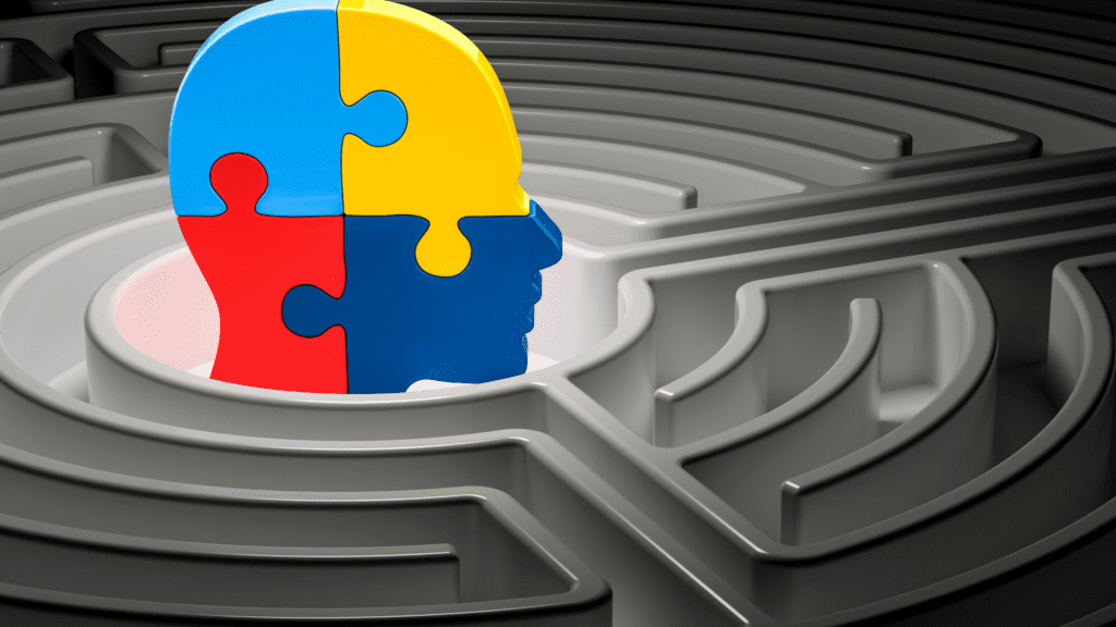 A colorful puzzle piece in the shape of a human head, placed in the center of a labyrinth, symbolizing mental challenges.
