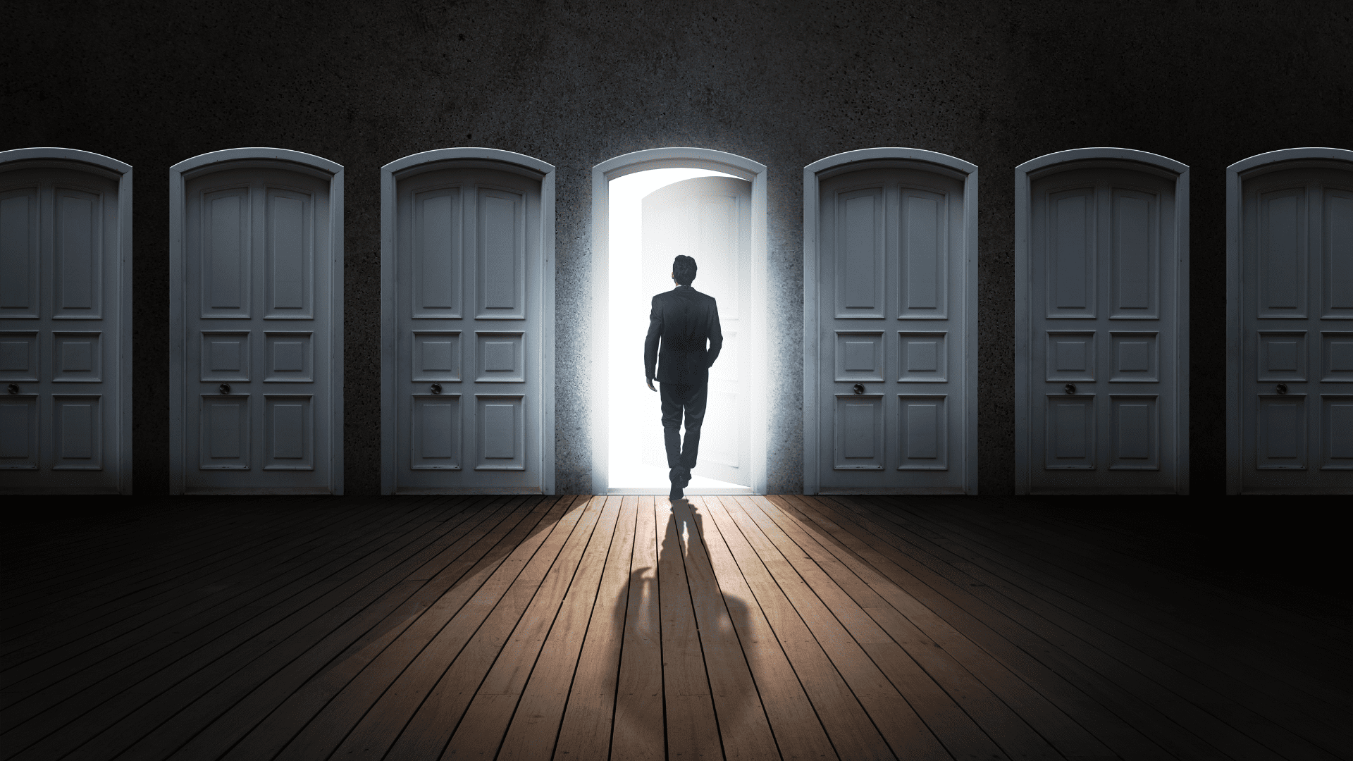 A man walking through an illuminated door symbolizing new career opportunities and work-life balance.