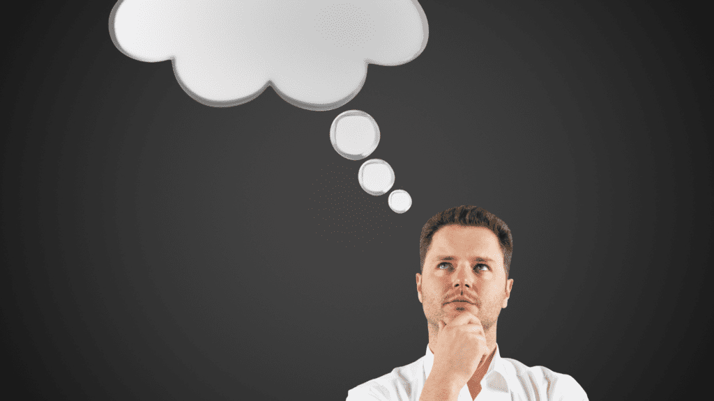 A man deep in thought with a blank thought bubble above his head, symbolizing the potential for cognitive flexibility and reframing thoughts.



