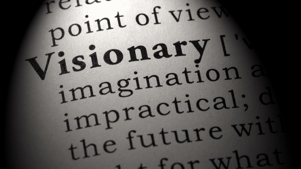 Close-up of the word visionary  in a dictionary, symbolizing the essence of a visionary mindset.

