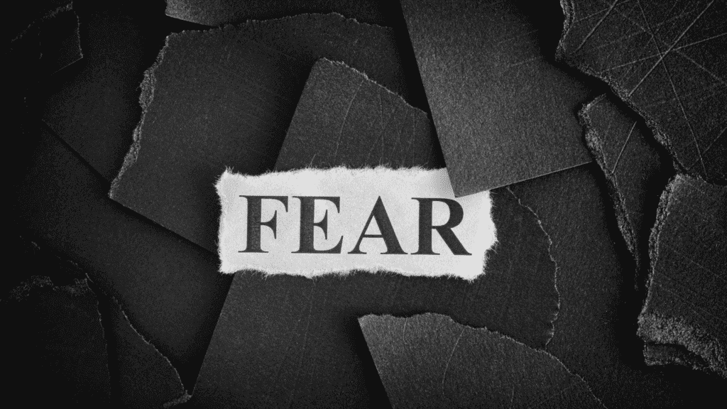 Torn paper with the word "FEAR" written on it, symbolizing paradoxical intention techniques.