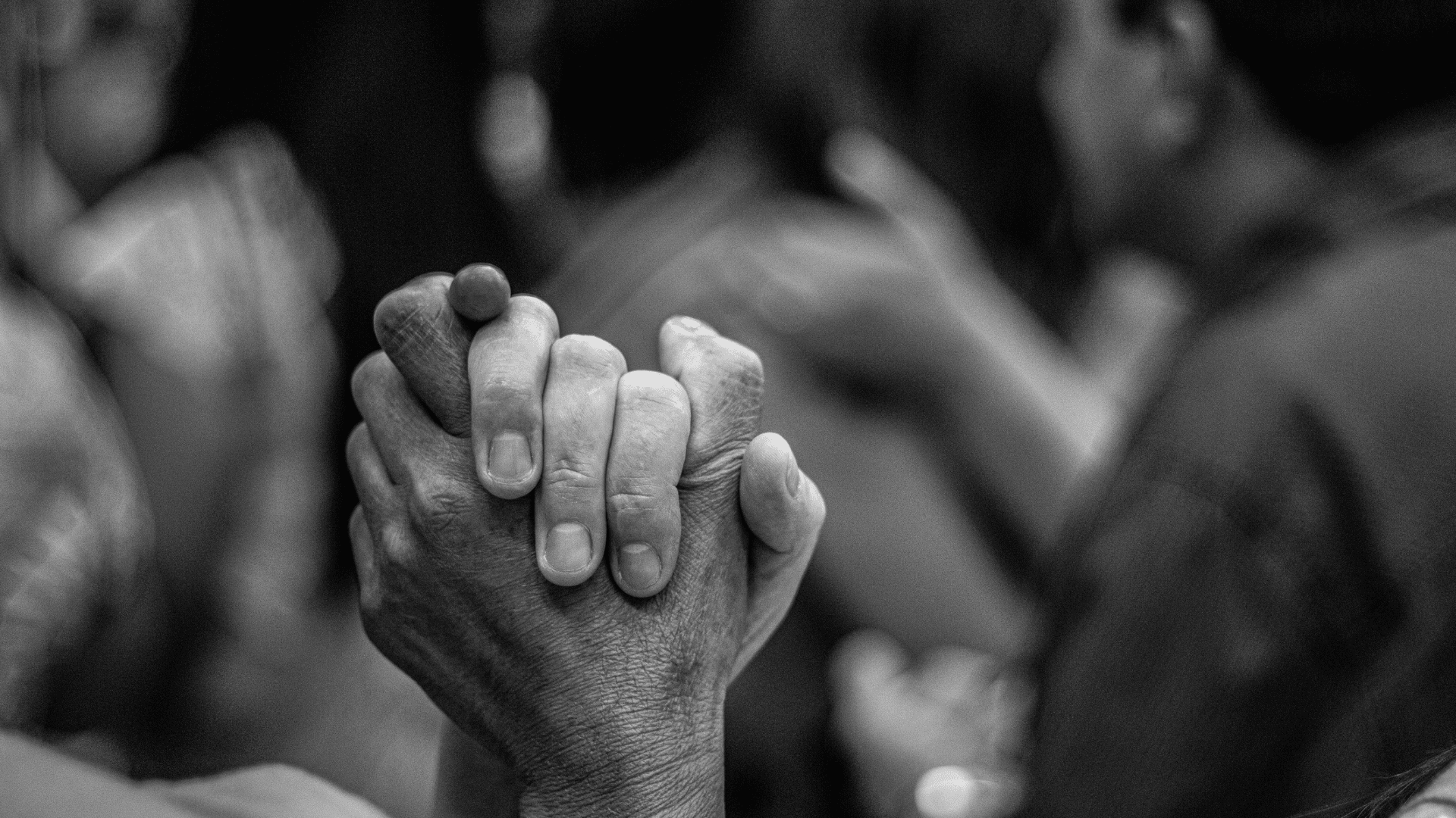 Two hands gripping each other firmly, representing support and the effort to rebuild trust.