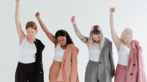 A diverse group of empowered women raising their fists in solidarity, symbolizing the evolving landscape of women's health priorities in 2025, emphasizing strength, resilience, and holistic well-being