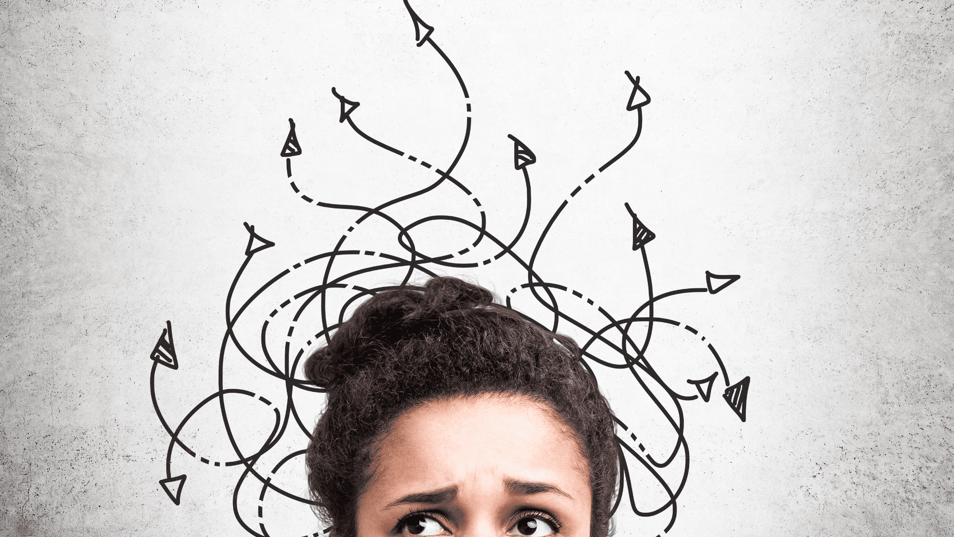 Confused woman looking up at tangled arrows representing the counterintuitiveness of the brain and chaotic thought patterns.