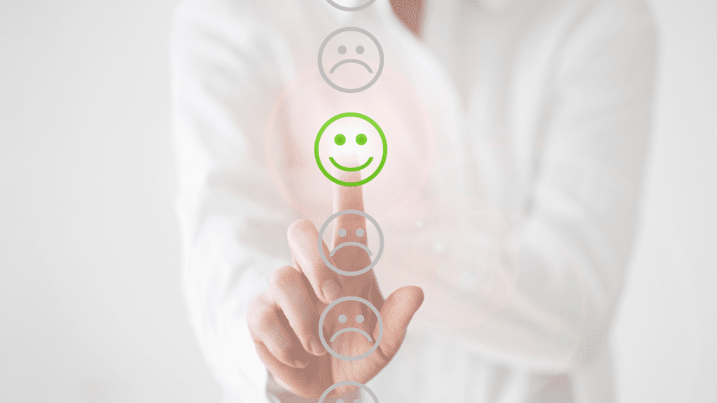 Person selecting a green smiley face on a virtual interface, representing positive emotional rewiring through neuroplastic momentum.




