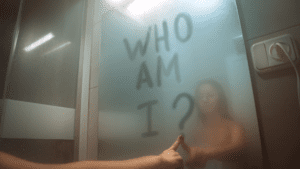 A fragmented mirror reflecting different parts of a face, representing confusion and self-identity crisis.