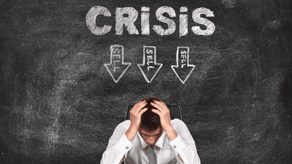 A stressed individual sitting with their head in their hands, surrounded by chalkboard arrows labeled sell, symbolizing the confusion and pressure of a self-identity crisis.

