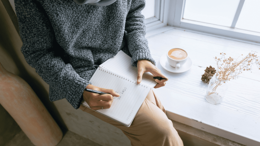 6 Steps to Building a Success-Focused Mindset: A Neuroscience Blueprint 2 Person journaling to enhance self-awareness, a key step in building a success-focused mindset.