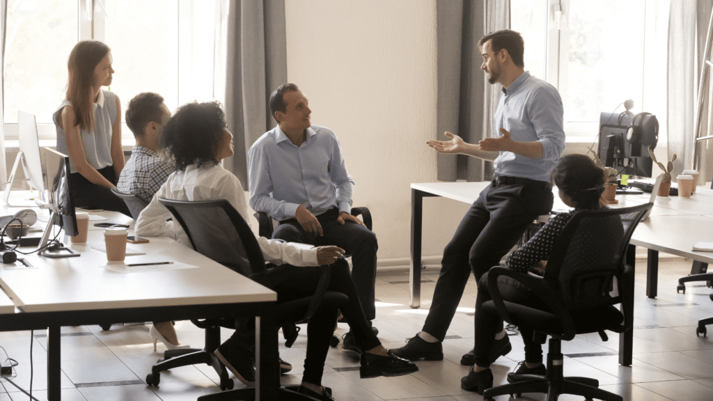 A team collaborating in a meeting to foster appreciation and reduce employees feeling underappreciated at work.