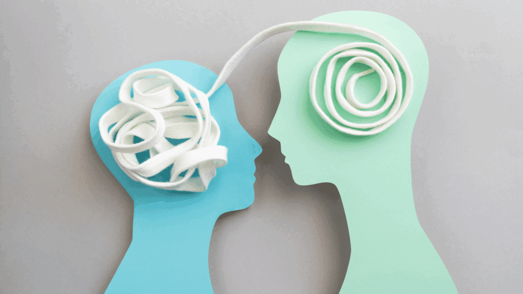 Two paper head silhouettes connected by a shoelace, showing tangled and organized thoughts in the neuroscience of insecurity





