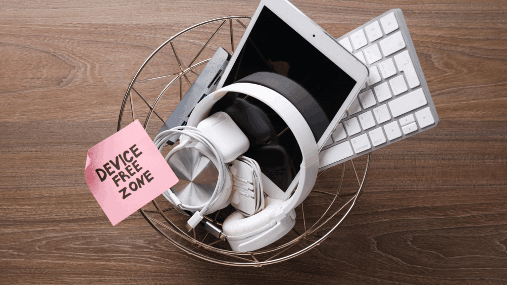 Basket filled with electronic devices and a note reading device free zone, representing a digital detox in action.