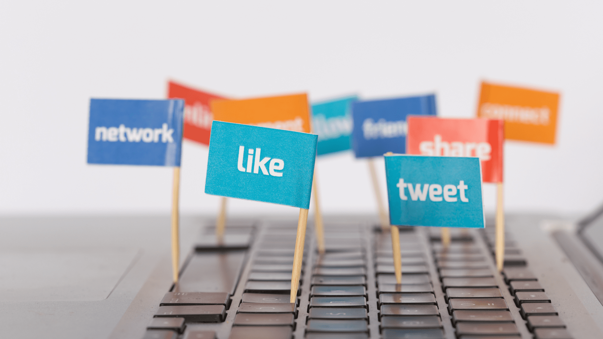 Social media and network flags on a keyboard, illustrating the distractions digital detox aims to reduce.