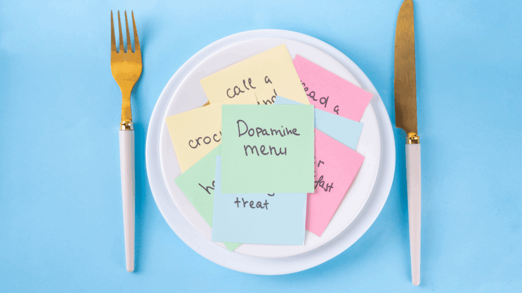 Dopamine Boosting Foods for Brain Health: Unlocking Nutrition’s Secret to Motivation and Focus 4 A plate with colorful notes labeled “Dopamine menu” surrounded by a gold fork and knife, symbolizing dopamine boosting foods choices.