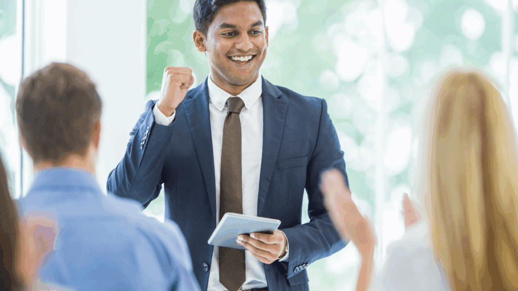 Dopamine Boosting Foods for Brain Health: Unlocking Nutrition’s Secret to Motivation and Focus 2 A confident professional celebrating success in a meeting, illustrating the impact of dopamine boosting foods on motivation.