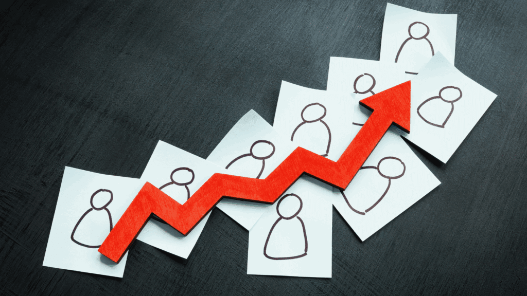 Upward red arrow over paper figures, illustrating leadership impact on organizational growth and team performance.



