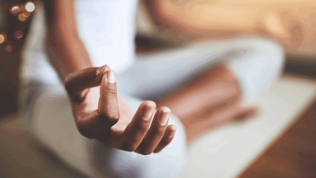 Close-up of hands in meditation mudra position, demonstrating mindfulness for anxiety practice.

