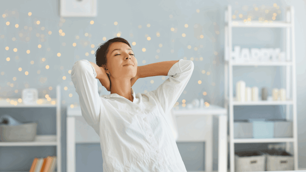 Person relaxing in a bright room after a neuroplasticity coaching session.