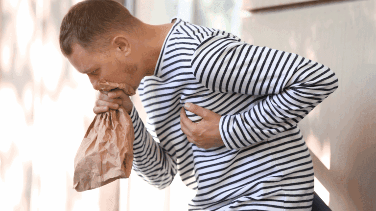 On the Blog 3 A person using a paper bag to manage symptoms, illustrating a physical response in the neuroscience of anxiety.