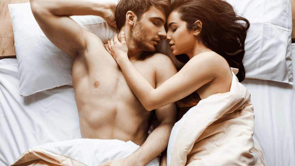 The Neuroscience of Sex Addiction: How the Brain Drives Compulsion 2 Aman and woman holding one another in bed representing the neuroscience of sex addiction.