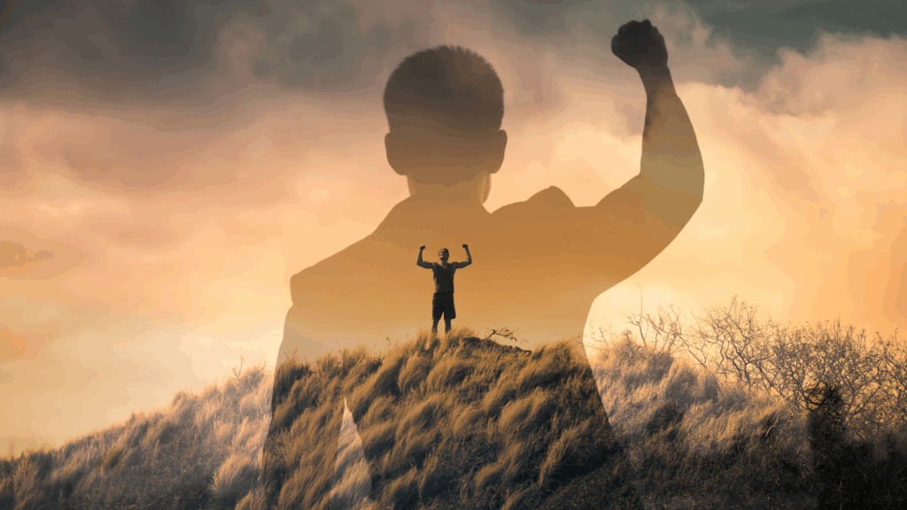 Silhouette of a person raising a fist in triumph on a hill, symbolizing achievement through the neuroscience of mental toughness.



