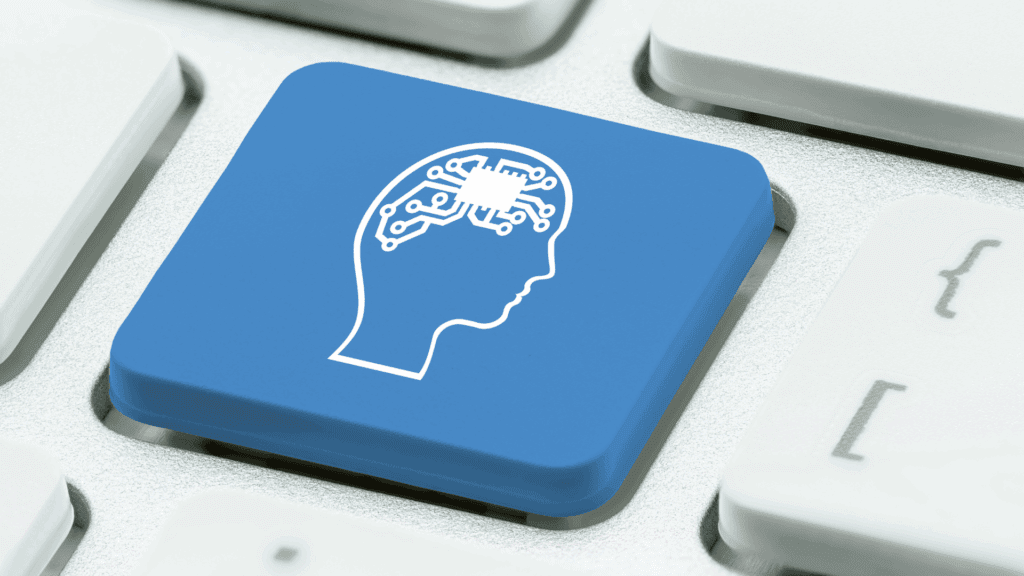 Blue keyboard key with a head and brain circuitry, representing the neuroscience of mental toughness in technology.


