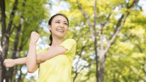 Smiling woman stretching outdoors, symbolizing the role of Brain-Based Learning in peak performance and well-being.