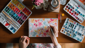 Creative Expression for Anxiety: How Art Rewires the Brain for Resilience 1 Person painting colorful watercolor flowers as a form of creative expression for anxiety and emotional release.