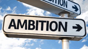 Escape Hustle Culture: Unlocking Secrets to Balance 2 Street sign with the word ambition, symbolizing the choice to escape hustle culture and redefine success.