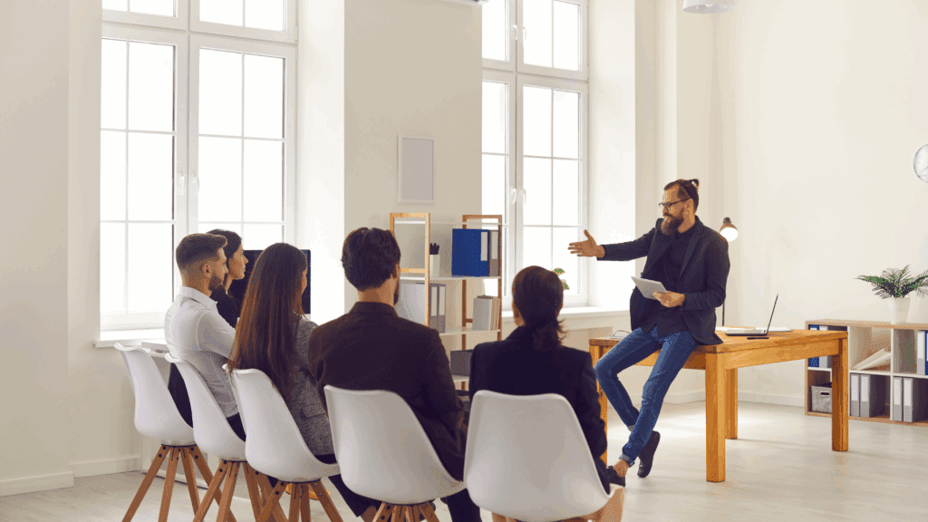 The Neuroscience of Leadership Presence: How to Command the Room 2 Man demonstrating leadership presence while leading a group discussion in a modern office setting.