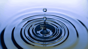 The Neuroscience of Micro-Changes: How Tiny Steps Transform Everything 2 Water droplet creating ripples, symbolizing the neuroscience of micro-changes and small actions leading to wider effects.