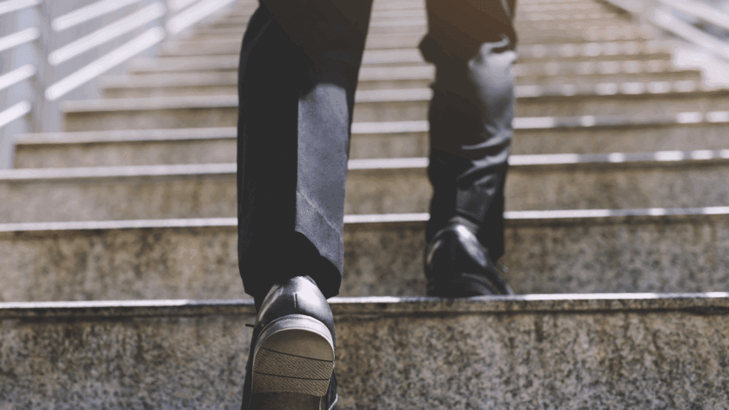 Close-up of a person walking up stairs, symbolizing progress and the neuroscience of micro-changes.