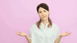 Neuroscience of Trusting Your Decisions: Clarity & Confidence 2 Woman shrugging with uncertain expression, symbolizing the neuroscience of trusting your decisions.