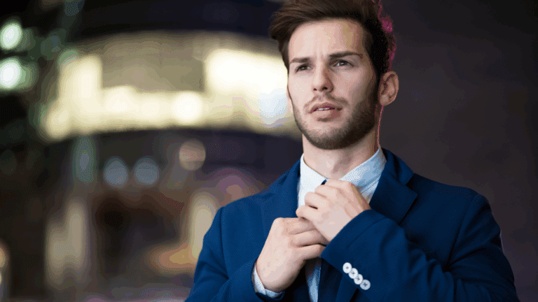 On the Blog 7 Confident young man adjusting tie, symbolizing the neuroscience of trusting your decisions with clarity and self-assurance.