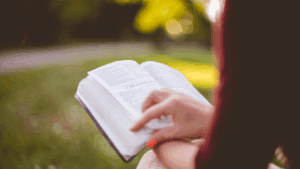 Hooked on YouTube Shorts: How Reward Loops Hijack Your Brain 2 Person reading a book outdoors, showing a healthy alternative to digital reward loops and endless scrolling.