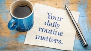 “Coffee cup and note reading your daily routine matters, symbolizing habit formation in Dopamine-Aware Leadership.”