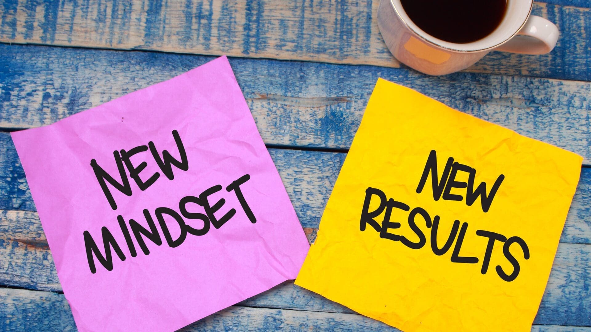 “Colorful notes reading ‘New Mindset’ and ‘New Results’ beside a cup of coffee, symbolizing positive change through Dopamine Coaching Neuroscience.”