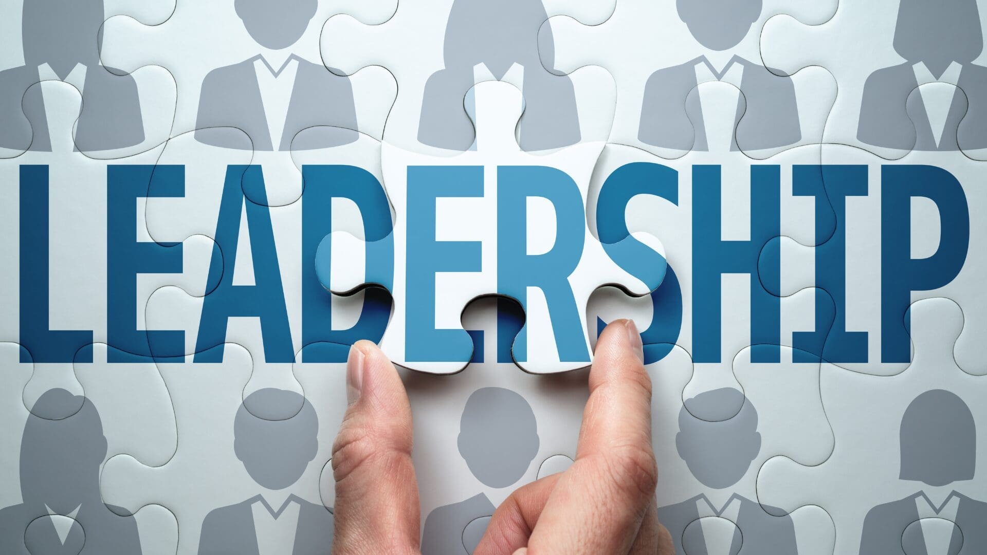 “Hands placing a final puzzle piece labeled leadership, symbolizing the integration of neuroscience into adaptive leadership practices.”