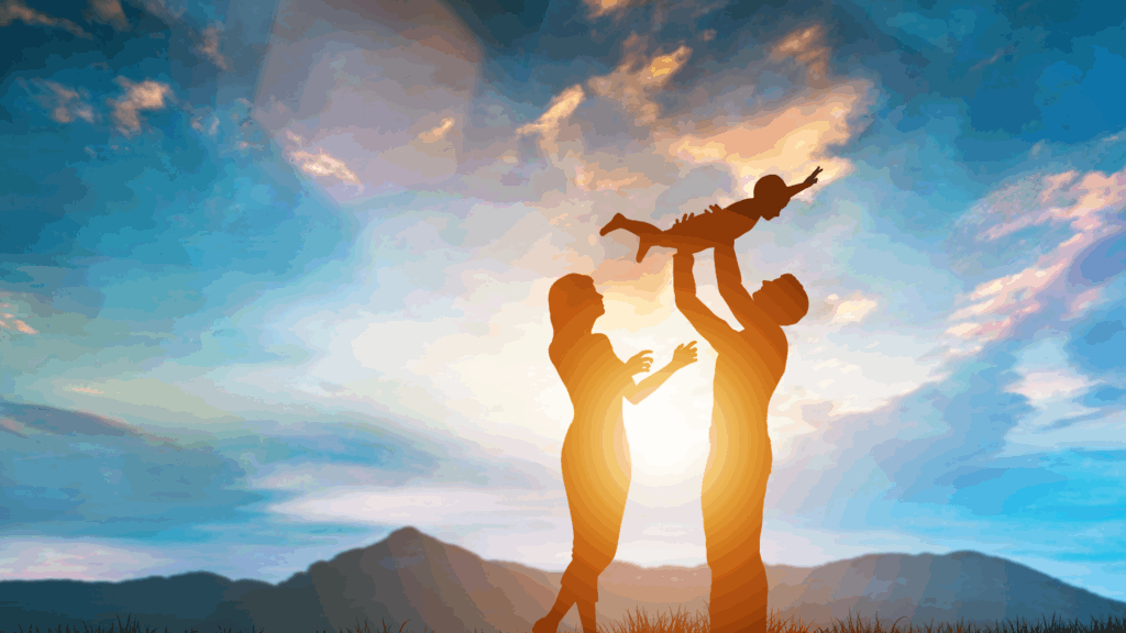 Silhouettes of two adults lifting a child against golden sunlight and blue sky, symbolizing the joy, connection, and life transformation achieved through dopamine coaching.

