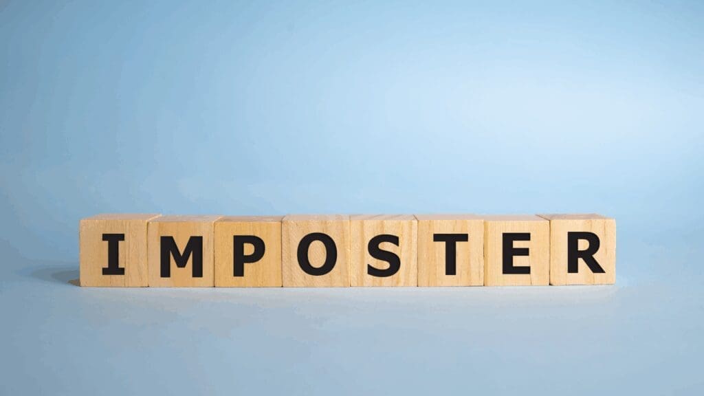 Wooden blocks spelling imposter, representing the core theme of imposter syndrome leadership coaching.