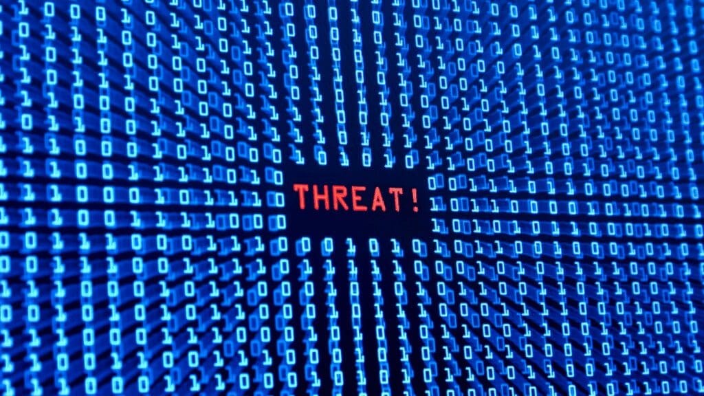 Red threat alert in binary code representing how amygdala detects threats in life coaching vs neuroscience coaching stress management