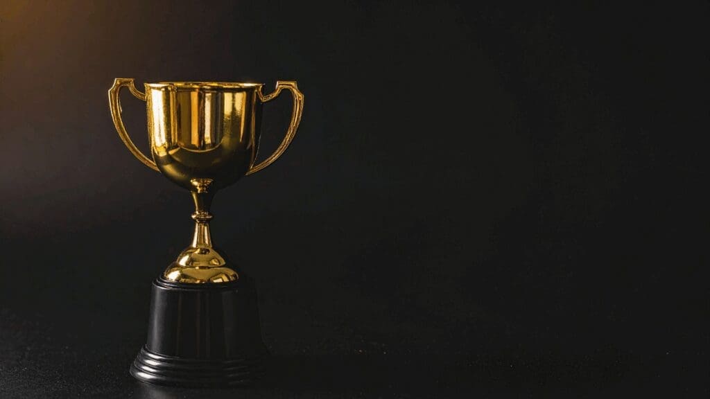 Gold trophy representing superior results achieved through life coaching vs neuroscience coaching transformation