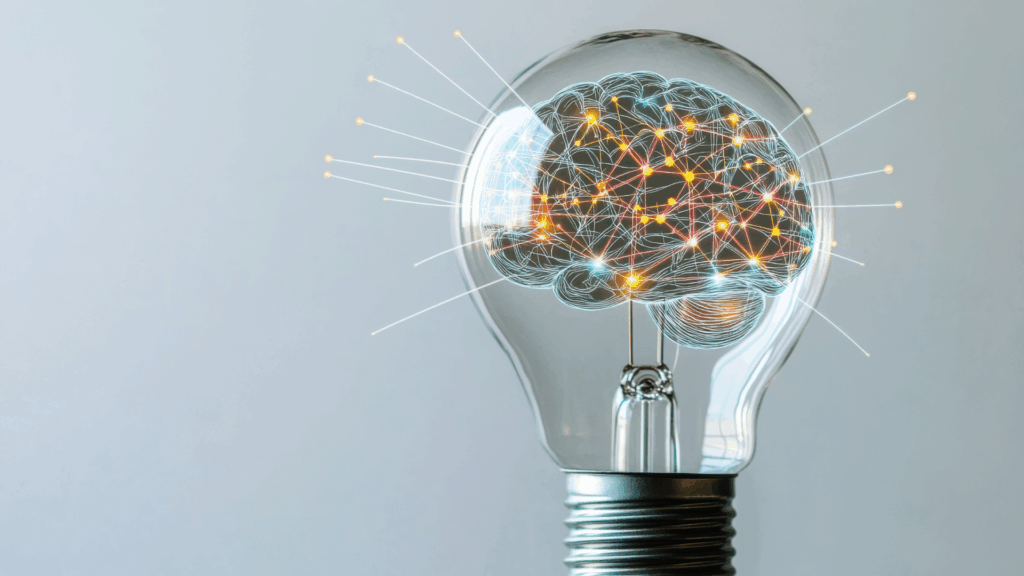 Life Coaching vs Neuroscience Coaching: A Complete Guide 4 Illuminated brain network inside lightbulb representing breakthrough insights in life coaching vs neuroscience coaching transformation